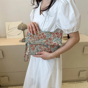 Ethnic floral envelope clutch with wristlet strap featuring colorful embroidery