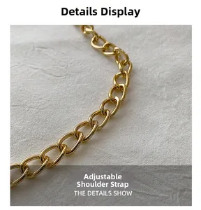 Detail of adjustable golden metal flat link chain strap on white pleated fabric texture