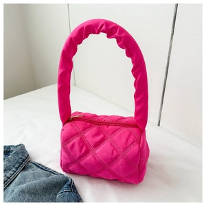 Close-up of fuchsia quilted nylon bag with padded handles and golden zipper detail