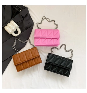 Detailed close-up of quilted geometric flap bags in pink, brown, and black with silver chains