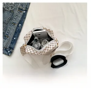 Top view showing interior capacity of white monogram camera bag with wide strap