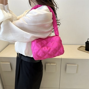Bright pink quilted puffer underarm bag with diamond stitching and nylon shoulder strap