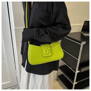 Neon green faux leather underarm bag with unique matching round clasp and thin strap