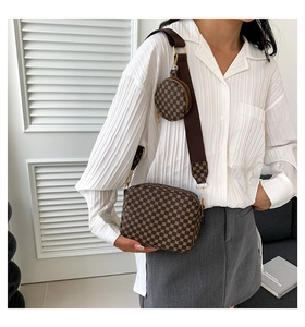 Detail of printed crossbody bag with detachable round coin purse and woven strap