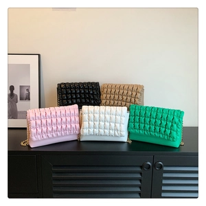Close-up of pleated cloud bags in five colors with sleek gold chain straps and PU finish
