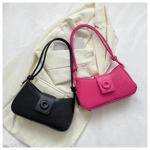 Detail of minimalist shoulder bags in black and magenta with metallic strap ends