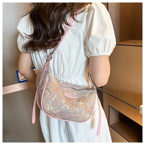 Detail of floral embroidered silk dumpling bag with pink leather strap on white outfit