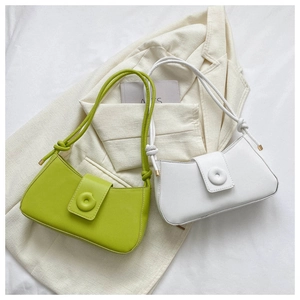 Detail of minimalist avocado green and white leather shoulder bags with knot straps