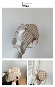 Detail of white monogram square bag with round coin purse and wide textile strap