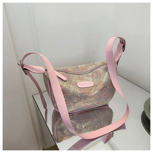 Detail of pink embroidered silk crossbody bag with adjustable wide leather strap