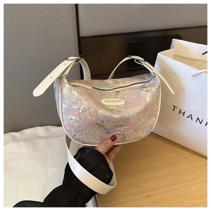 Detail of lavender jacquard texture and white leather strap on the crescent bag