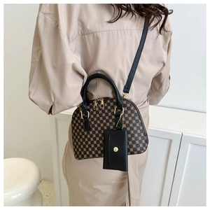 Retro dome shell bag featuring brown geometric dots pattern and black shoulder strap