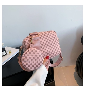 Detail of pink floral printed crossbody bag with detachable round coin purse and gold hardware
