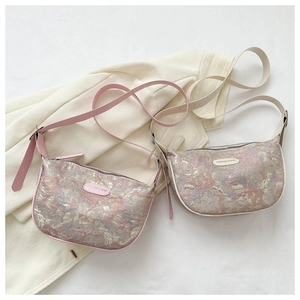Detail of hobo half-moon bag with textured jacquard fabric and adjustable strap