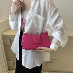 Minimalist rose red PU leather shoulder bag with circular detail on the front flap