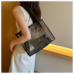 Detail of transparent PVC tote with colorful studs and black inner pouch for women