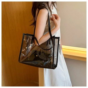 Detail of transparent PVC tote bag with colorful gemstones and black inner pouch