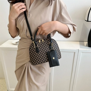 Vintage brown shell handbag with retro geometric patterns and matching coin purse charm