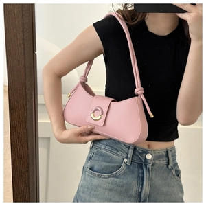 Mirror selfie showing the pale pink underarm bag with champagne gold magnetic buckle