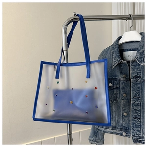 Detail of blue transparent tote bag with rhinestones and inner zippered pouch