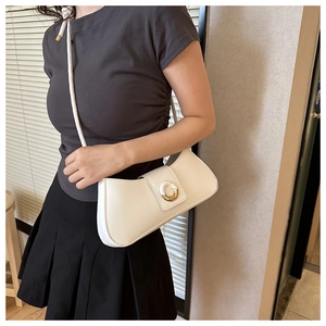 Model wearing a white leather underarm bag with gold metal buckle for daily style