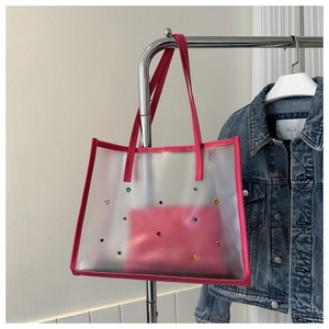 Detail of rose pink transparent tote bag with colorful rhinestones and inner pouch