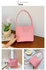 Detail view of pink nylon shoulder bag showing minimalist texture and handle design