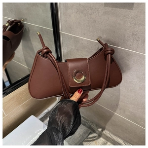 Detail of a brown PU leather underarm bag featuring a gold half-round metal buckle