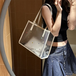 Transparent PVC tote bag with colorful rhinestones and off-white leather handles