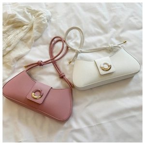 Detail of pink and white baguette underarm bags with metal ring and knotted straps