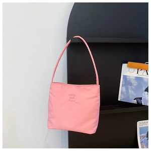 Close-up of pink nylon shoulder bag featuring embroidered marlon and ebony logo