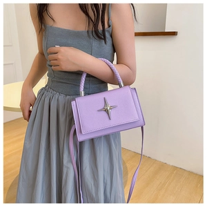 Lavender purple crossbody bag with silver star emblem and woven handle detail