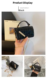 Detail of black faux crocodile leather crossbody bag with elegant gold metal bar accent