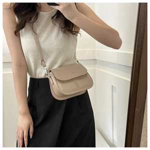 Fashionable beige small square crossbody bag shown on model for a trendy summer look