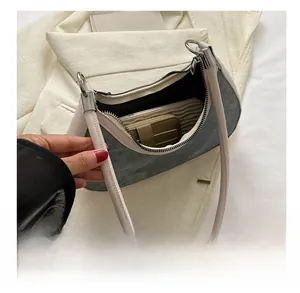 Internal storage capacity of crescent shoulder bag showing wallet and card holder