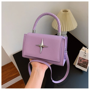 Detail of lavender leather handbag with braided handle and silver star hardware