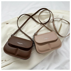 Detail of trendy crossbody flap bags in dark brown and beige with fashion print