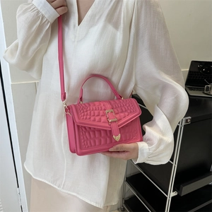 Pink crocodile pattern handbag with golden heart hardware and crossbody strap