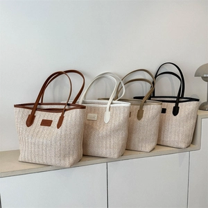 Large straw tote bags in multiple colors featuring leather straps and fashion patch labels