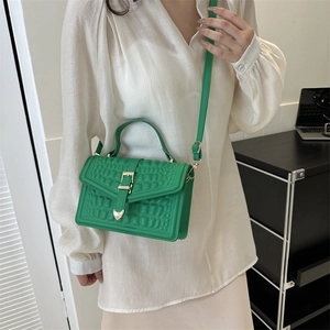 Green crocodile pattern handbag with golden buckle and adjustable shoulder strap