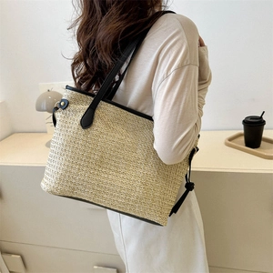 Minimalist straw tote bag with black leather straps and trim for summer fashion