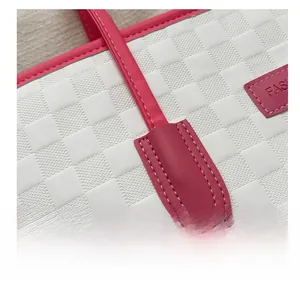 Détail des poignées roses renforcées et texture tissée d'un sac cabas blanc