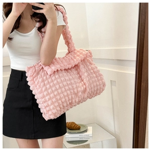 Pink bubble textured large tote bag styled in a minimalist room for daily casual use