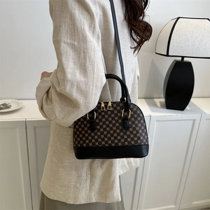 Classic retro monogram boston bag with golden hardware and leather strap on model