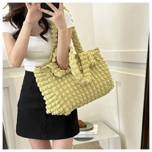 Macro shot of bright yellow bubble texture fabric and spacious tote bag shoulder strap