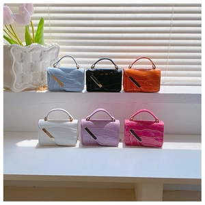 Detail of colorful crocodile pattern mini crossbody bags on white display steps