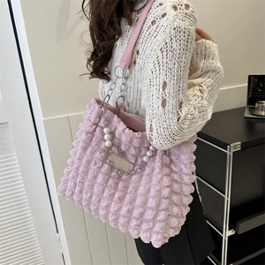 Pink bubble texture tote bag with pearl and chain straps on model for casual chic style