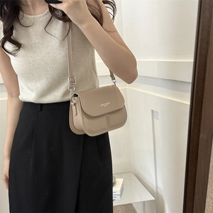 Minimalist beige leather crossbody square bag with adjustable strap and silver hardware