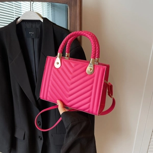 Fuchsia V-quilted small square handbag with cylindrical woven handle and gold hardware