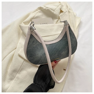 Detailed close-up of gray denim hobo bag with pink leather trim and silver zipper